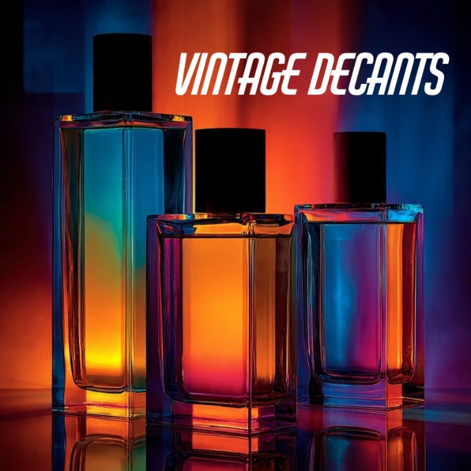 Three vintage-style decanters with gradient colors on a reflective surface, branded 'Vintage Decants'.